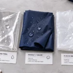 Perbandingan Bahan Jas Hujan PVC Parasut Taslan